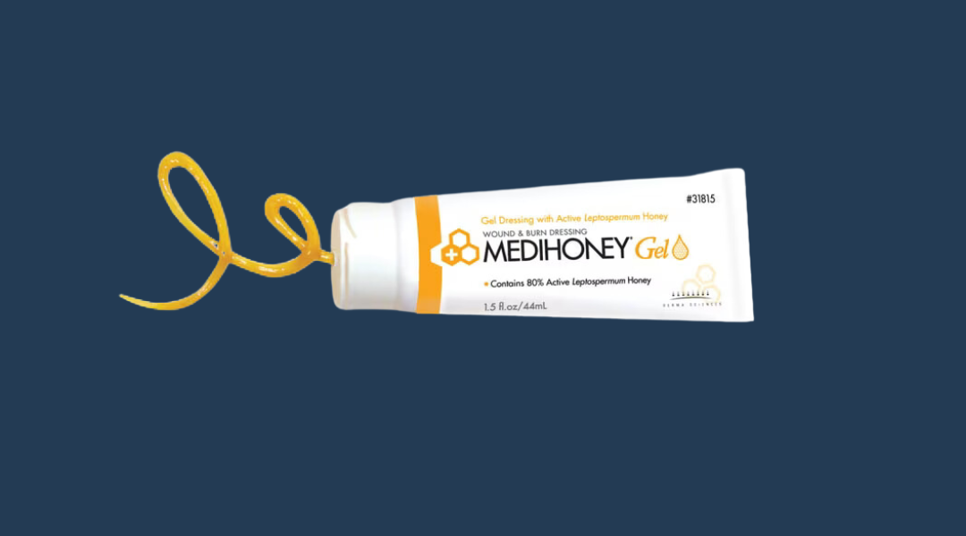 Tube of Medihoney wound care gel on a clean, blue background